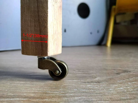 1 Inch Swivel Stem Ball Caster Wheel Zinc Alloy Antique Brass with wooden leg on floor