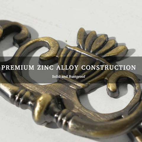 Close-up of Antique Brass Drop Bail Drawer Pull showing zinc alloy construction and vintage style design elements.