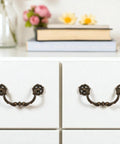 4-Pack Antique Brass Drawer Pulls 4.5 Inch Center-to-Center Drop Bail Dresser Handles shown on white dresser