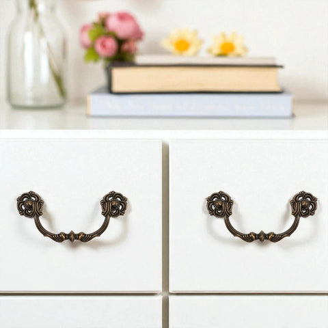4-Pack Antique Brass Drawer Pulls 4.5 Inch Center-to-Center Drop Bail Dresser Handles shown on white dresser