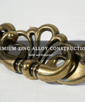 Close-up of Antique Brass Bail Drawer Pulls 4 Pack With 3-3/8 Inch Hole Centers, showcasing zinc alloy leaf scroll design.