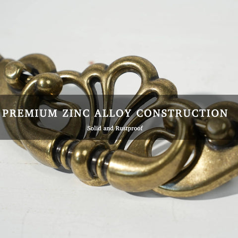 Close-up of Antique Brass Bail Drawer Pulls 4 Pack With 3-3/8 Inch Hole Centers, showcasing zinc alloy leaf scroll design.