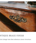 Antique Brass Drop Bail Drawer Pulls Six Pack With Two And A Half Inch Hole Centers on wooden dresser showcasing vintage style