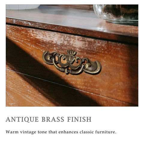 Antique Brass Drop Bail Drawer Pulls Six Pack With Two And A Half Inch Hole Centers on wooden dresser showcasing vintage style