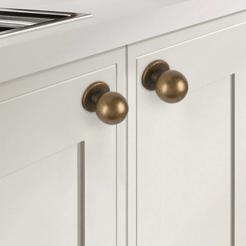 Antique Brass Kitchen Cabinet Knobs Set Of 10 For Solid Wood And Metal Drawers shown installed on white cabinet doors