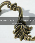 Close-up of Antique Brass Drawer Pulls Set Of 6 With Leaf Inspired Design For Dresser Cupboard And Bedroom Furniture, 2-1/2 Inch Hole Center Cabinet Handles showcasing zinc alloy construction.