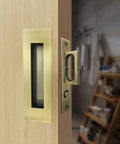 Recessed Finger Flush Pulls With Edge Pull In Antique Brass, 4.72 Inch Sliding Closet Door Handles installed on light wood door.