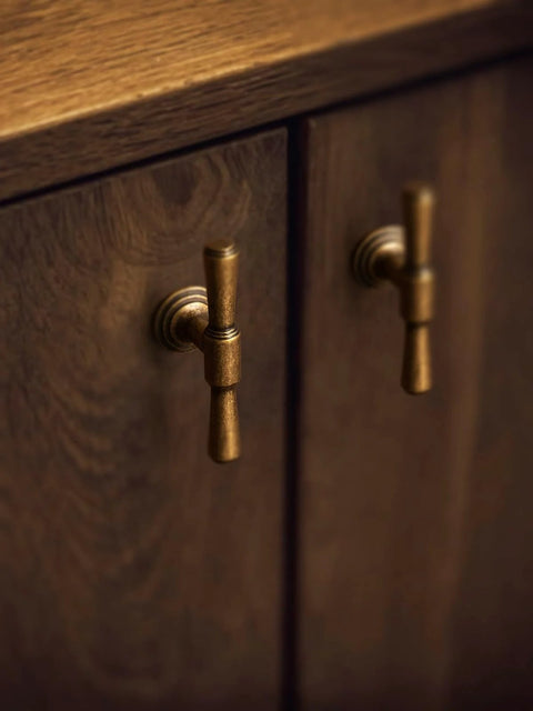Antique Brass Cabinet Knobs Five Pack Single Hole Vintage Drawer Knobs Zinc Alloy Handles installed on wooden cabinet