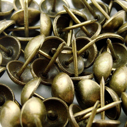 Antique brass upholstery tacks secure fabric, leather, and trim to wood frames and panels with a durable, decorative finish