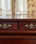 Wooden dresser with 4 Pack 3.25 Inch Center To Center Antique Bronze Bail Drawer Pulls, vintage style, in a rustic room setting.