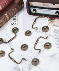 Four 3.6 Inch Vintage Bail Pull Handles Antique Bronze Furniture Hardware Set with screws on marble surface