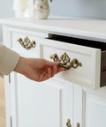Person opening drawer with 4 Pack 3.25 Inch Center To Center Antique Bronze Bail Drawer Pulls Drop Swing Handles on cabinet