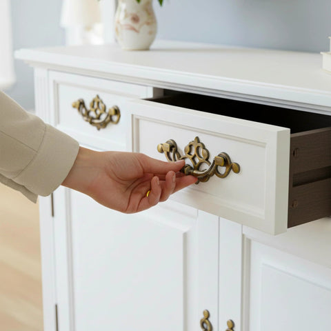 Person opening drawer with 4 Pack 3.25 Inch Center To Center Antique Bronze Bail Drawer Pulls Drop Swing Handles on cabinet
