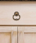 Vintage Drop Ring Pulls Set of 4 in Antique Bronze for cabinets installed on light wood wardrobe.
