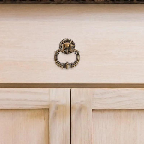 Vintage Drop Ring Pulls Set of 4 in Antique Bronze for cabinets installed on light wood wardrobe.