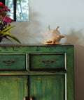 Vintage dresser with 8 Pack Antique Bronze Baroque Style Drop Bail Drawer Pulls With 2 Inch Hole Centers installed, floral decor on top