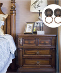 Bedroom scene with wooden nightstand featuring 6 Piece Antique Drawer Pull Ring Set With M4 X 25 Mm Screws Included for vintage decor.