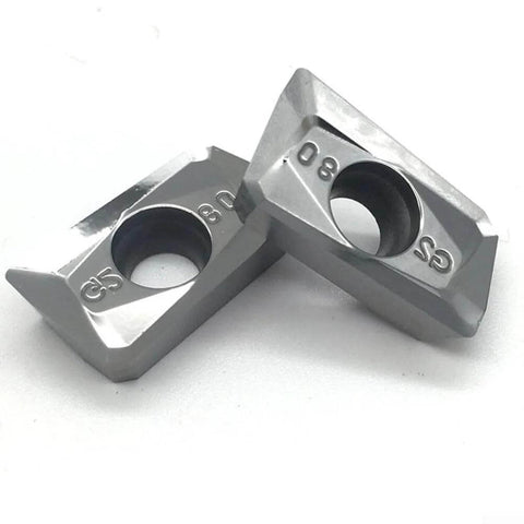 Close-up of two APKT1604PDFRG2 carbide inserts for aluminum finishing and semi-finishing, wear resistant for non-ferrous metal machining.