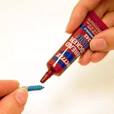 Applying Removable Thread Locker Blue 242 to bolt to prevent loosening and corrosion, medium strength, ideal for power equipment, 6 ml pack.
