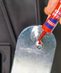 Applying Permanent Thread Lock And Seal For Nuts Bolts And Fasteners High Strength Red 271 to a bolt on metal machinery part