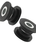 Two black bushing and sleeve components from Eight Piece Absorber Shock Bushing And Bearing Sleeve Kit For Arctic Cat ATVs.
