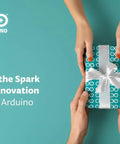 Gift box wrapped in Arduino-themed paper with a white ribbon, exchanged between two people, background showing Arduino logo.