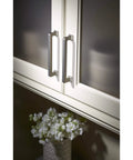 Ascendra 5-1/16 Inch Center To Center Cabinet Pull In Honey Bronze From The Transcend Series installed on white cabinets