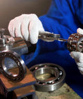 Deep groove ball bearings set, chrome steel, double sealed, 5/8 in ID, 1-3/8 in OD, 10 pcs, shown with gloved hands and vise