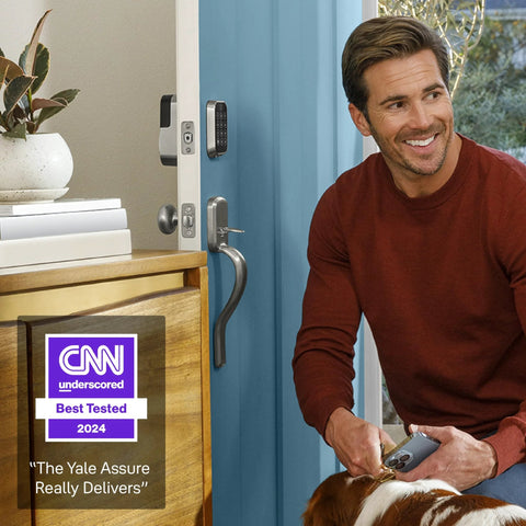 Man with dog near Assure Lock 2 Deadbolt With WiFi Keypad For Smart Home Entry Code Entry And Remote Access Keyless Entry Via Keypad And App Auto Lock And DoorSense Fits Doors By Replacing A Standard Deadbolt Easy Installation For Remote Access And WiFi Connectivity