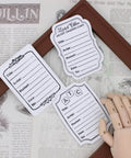 ATC Cards Die Set For Scrapbooking And DIY Card Making displayed on a vintage magazine, showing artist trading card designs