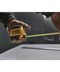 Person using Atomic Compact 30 Ft Tape Measure With Finger Brake for Precision and One Hand Quick Measurement on a job site