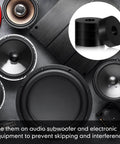 Array of audio subwoofers and electronic equipment components with anti-vibration pads for preventing skipping and interference.