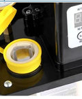 Close-up of 110V Auto Lube Pump With Digital Control and Dual Displays Plus Pressure Gauge, showing open reservoir and control panel.
