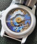 Watch back view showing Fifty Fathoms design, visible gears, and strap attachment point, suitable for link repair with screw tube bar.