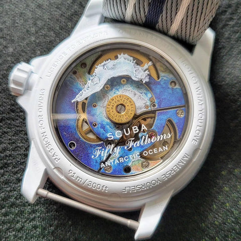 Watch back view showing Fifty Fathoms design, visible gears, and strap attachment point, suitable for link repair with screw tube bar.