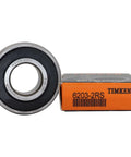 Timken 6203-2RS ball bearing next to its packaging box, illustrating product details and branding.