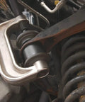 Ball Joint Press Tool Kit For Cars 10-Piece Set With Seat Clamp, shown in use on automotive suspension for ball joint removal.