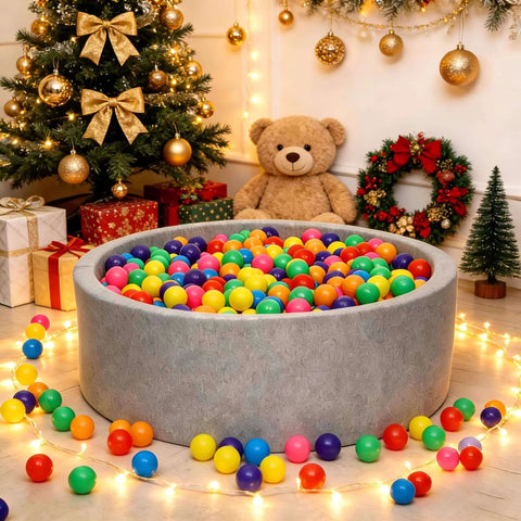 Ball Pit Balls Phthalate Free BPA Free Crush Proof Plastic - 7 Bright Colors in a play area with Christmas decor and teddy bear