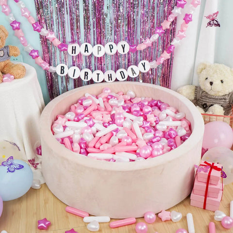 Ball Pit Balls for Toddlers, Pack of 200 BPA Free Phthalate Free Crush Proof Plastic Pit Balls in a soft pink foam pit at a birthday party.
