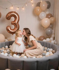 Child and parent in pastel ball pit with balloons, using Ball Pit Balls for Toddlers Kids Plastic Balls for Ball-Pit Playpen Pool Baby Play Pastel BPA-Free Non Toxic Play Pastel Crush Proof Bal Beige Light Gray White 100pcs.