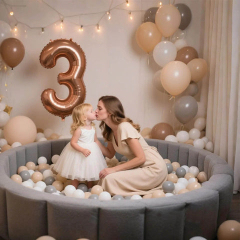 Child and parent in pastel ball pit with balloons, using Ball Pit Balls for Toddlers Kids Plastic Balls for Ball-Pit Playpen Pool Baby Play Pastel BPA-Free Non Toxic Play Pastel Crush Proof Bal Beige Light Gray White 100pcs.
