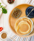 10 inch bamboo lazy susan pantry organizer with rotating tray, round bamboo turntable holding pancakes and dishes on countertop.