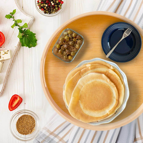 10 inch bamboo lazy susan pantry organizer with rotating tray, round bamboo turntable holding pancakes and dishes on countertop.