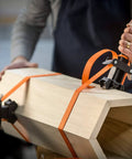 Adjustable Clamp Pony 1225 Rapid Acting Band Clamp With Non Marring 1x1 Inch Jaws securing an irregular wooden shape