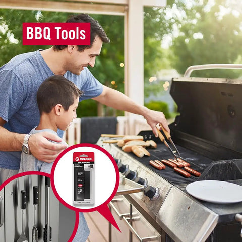 Father and son grilling with BBQ tools, Velcro brand adhesive featured for organizing, outdoor setting with food on grill.