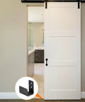 Floor Guide For Sliding Barn Doors Two Pack In Carbon Steel With Flexible Adjustable U Bracket And Flush Bottom Mount Flat Swing Stopper Black Finish Easy Install For Durable Track Alignment And Quiet Operation shown installed on a white door