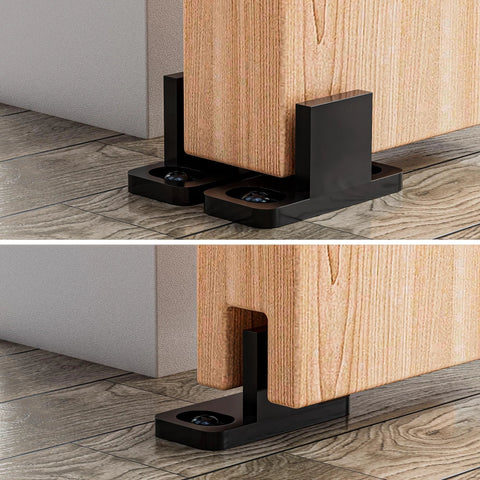 4 Pieces Barn Door Floor Guide Set For Sliding Closet Doors POM Plastic Bottom Track Guide Wall Mounted Adjustable For Grooved And Non Grooved Doors Includes Bypass Pocket And Screws Matte Black installed view showing black guides under wooden barn doors.