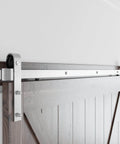Close-up of 10 Feet Brushed Nickel Barn Door Hardware Kit installed on wooden door, showing heavy-duty sliding track and J Shape hanger