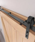Close-up of 8FT Barn Door Hardware Kit with Heavy Duty Sliding Track, J Shaped Carbon Steel System on wooden interior door.