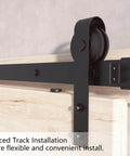 Close-up of 6.6FT Barn Door Hardware Kit with Heavy Duty Modular Sliding Track on wood door, J Shaped Carbon Steel System